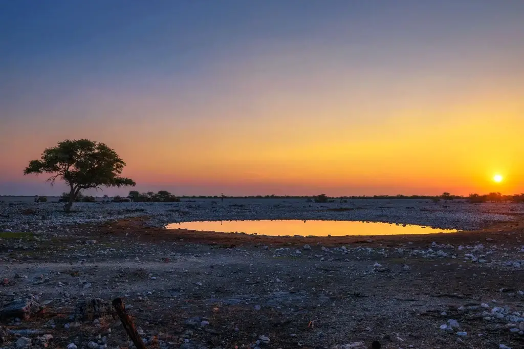 Okaukuejo Camp 8 sunset-over-the-waterhole-of-okaukuejo-resort-in-etosha-namibia