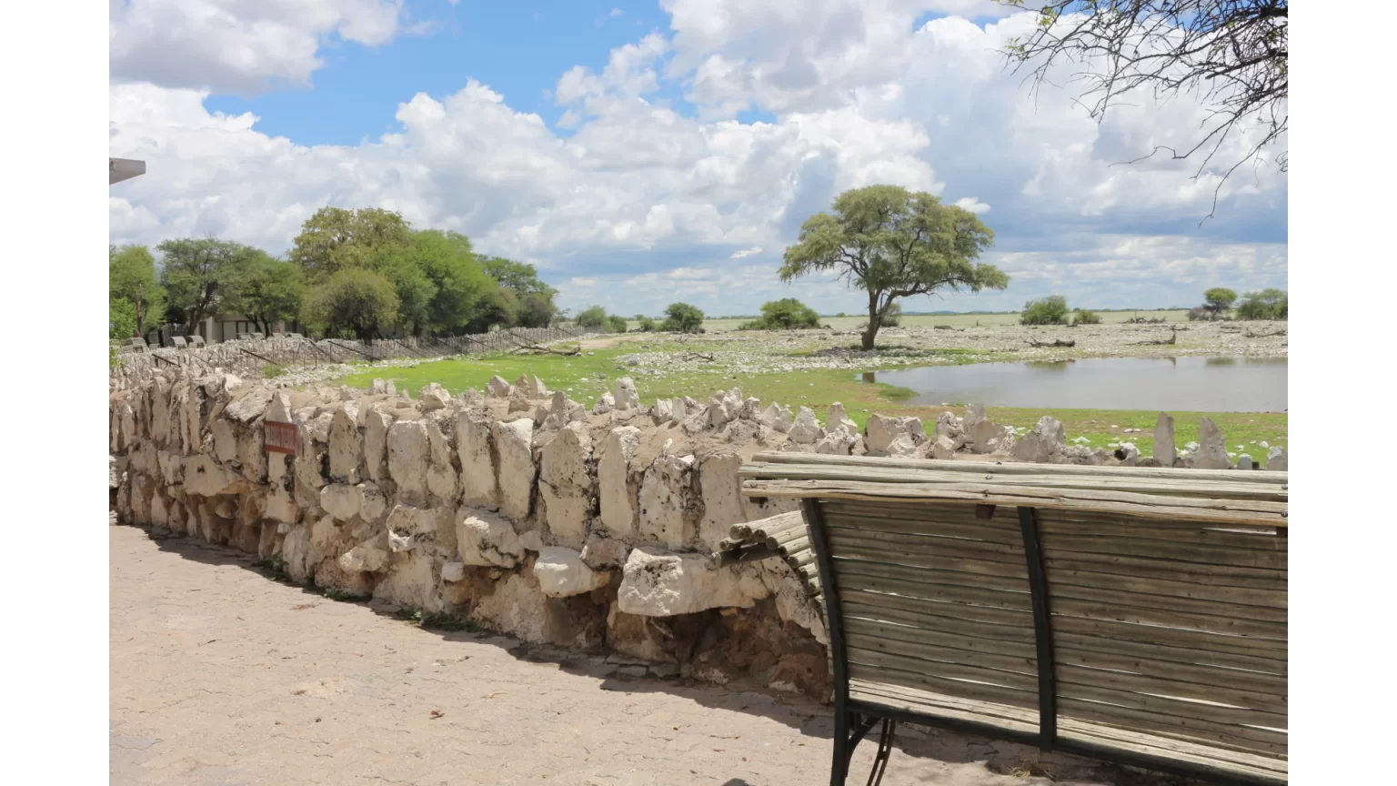 Stone viewing wall and bench overlooking the waterhole at Okaukuejo Camp