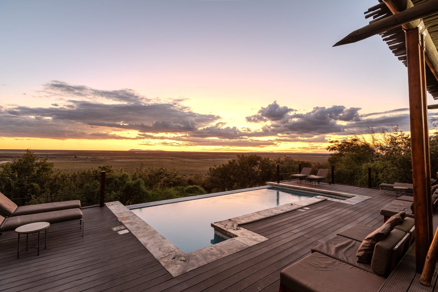 Pool deck at sunset overlooking western Etosha from Dolomite Camp