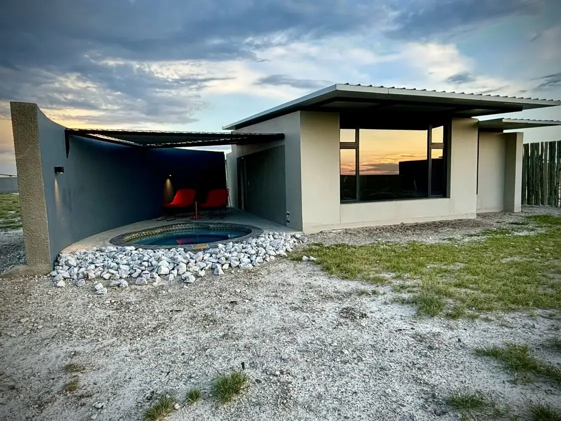 Etosha King Nehale Rates 2026 & Booking — Lodge at King Nehale Gate, Northern Etosha 7 Bungalow with private plunge pool and red loungers at sunset at Etosha King Nehale