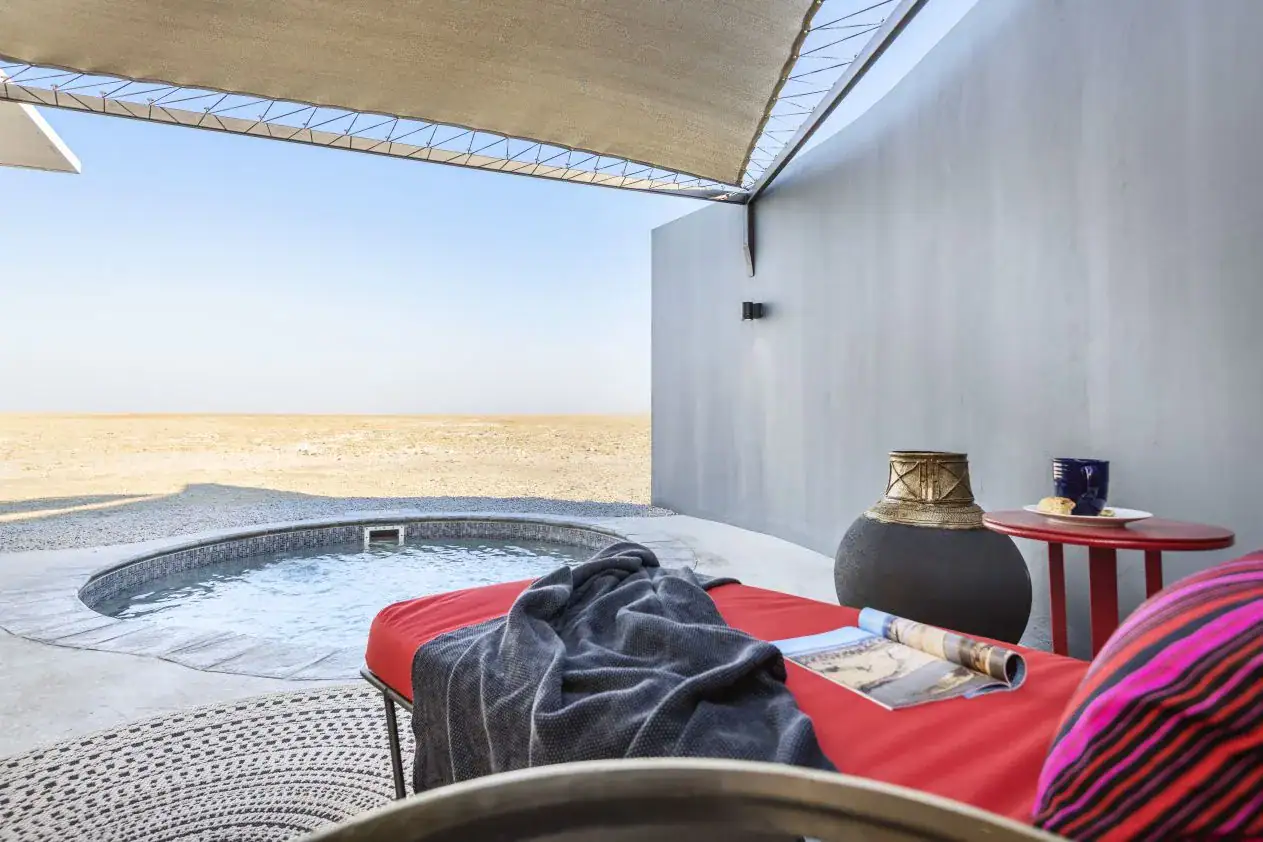 Etosha King Nehale Rates 2026 & Booking — Lodge at King Nehale Gate, Northern Etosha 3 Private plunge pool with shaded red daybed overlooking the plains at Etosha King Nehale